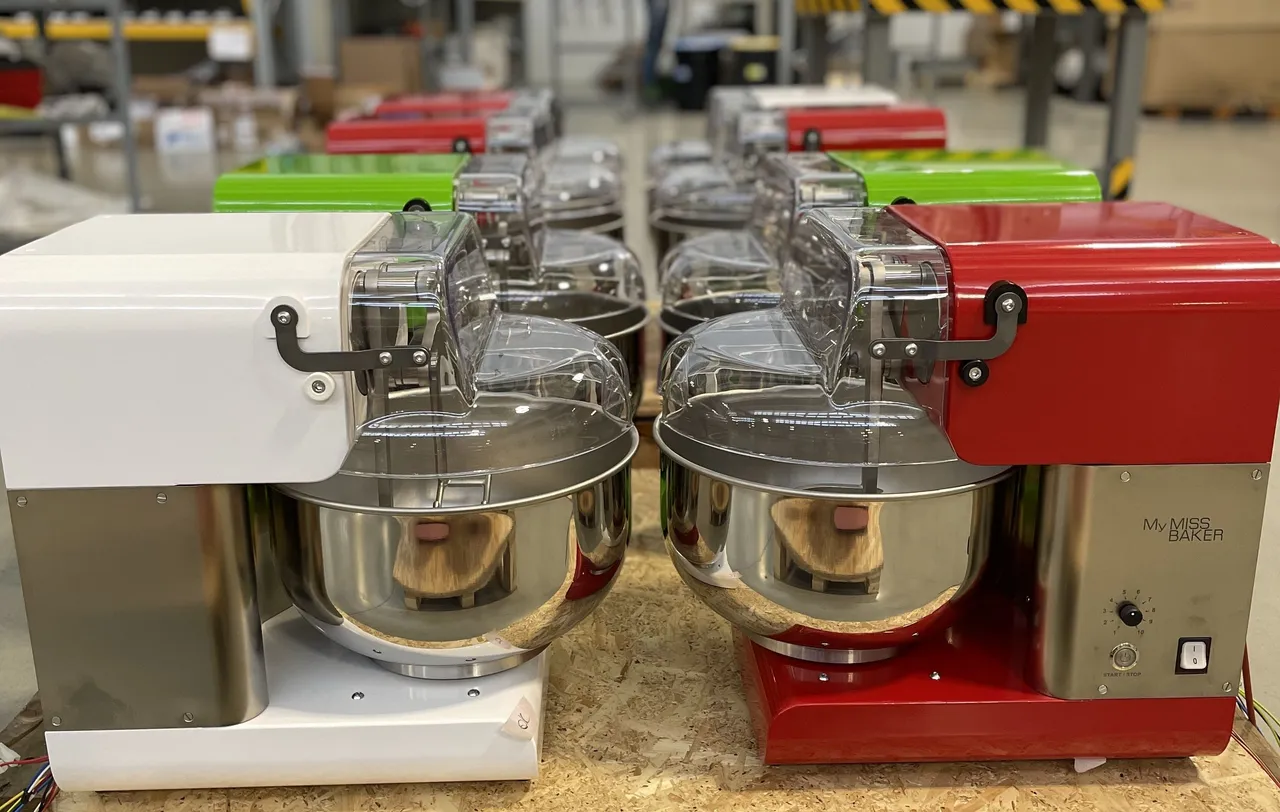 White and red My Miss Baker units on the assembly line, front view.